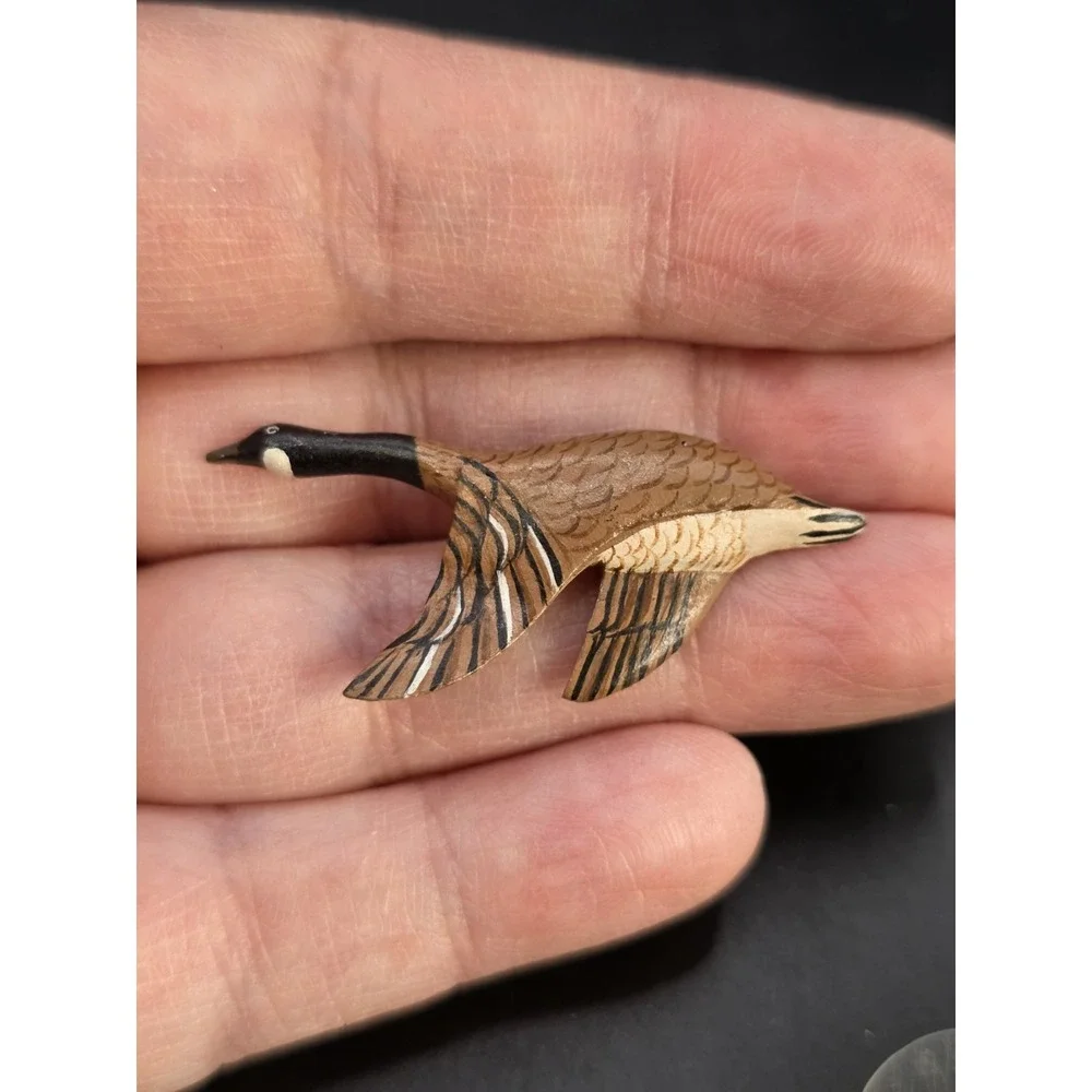 small, hand-carved and painted wooden Canada goose pin